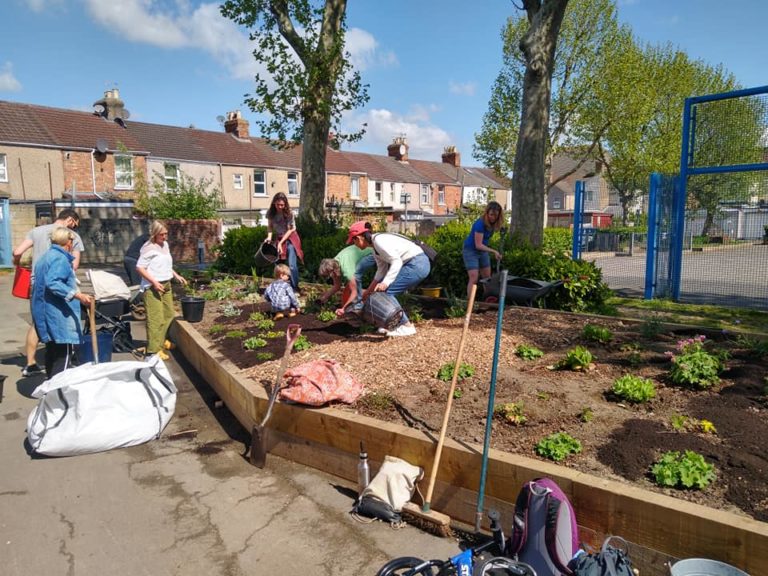 Volunteers planting a raised bed