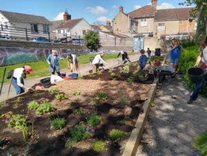 Volunteers planting a bed at Cambria Bridge Community Garden