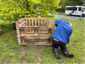A volunteer making a homemade compost bin at Pipers Way