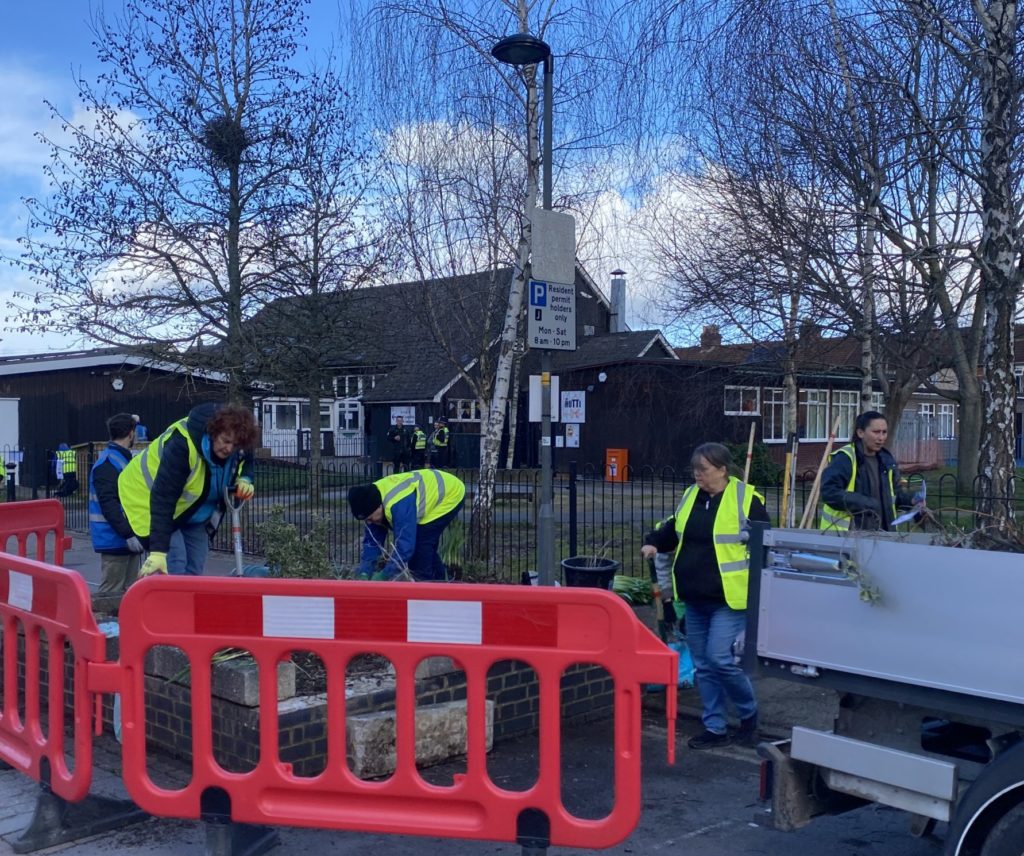 Volunteers are replanting a raised bed in the streets of Broadgreen.
